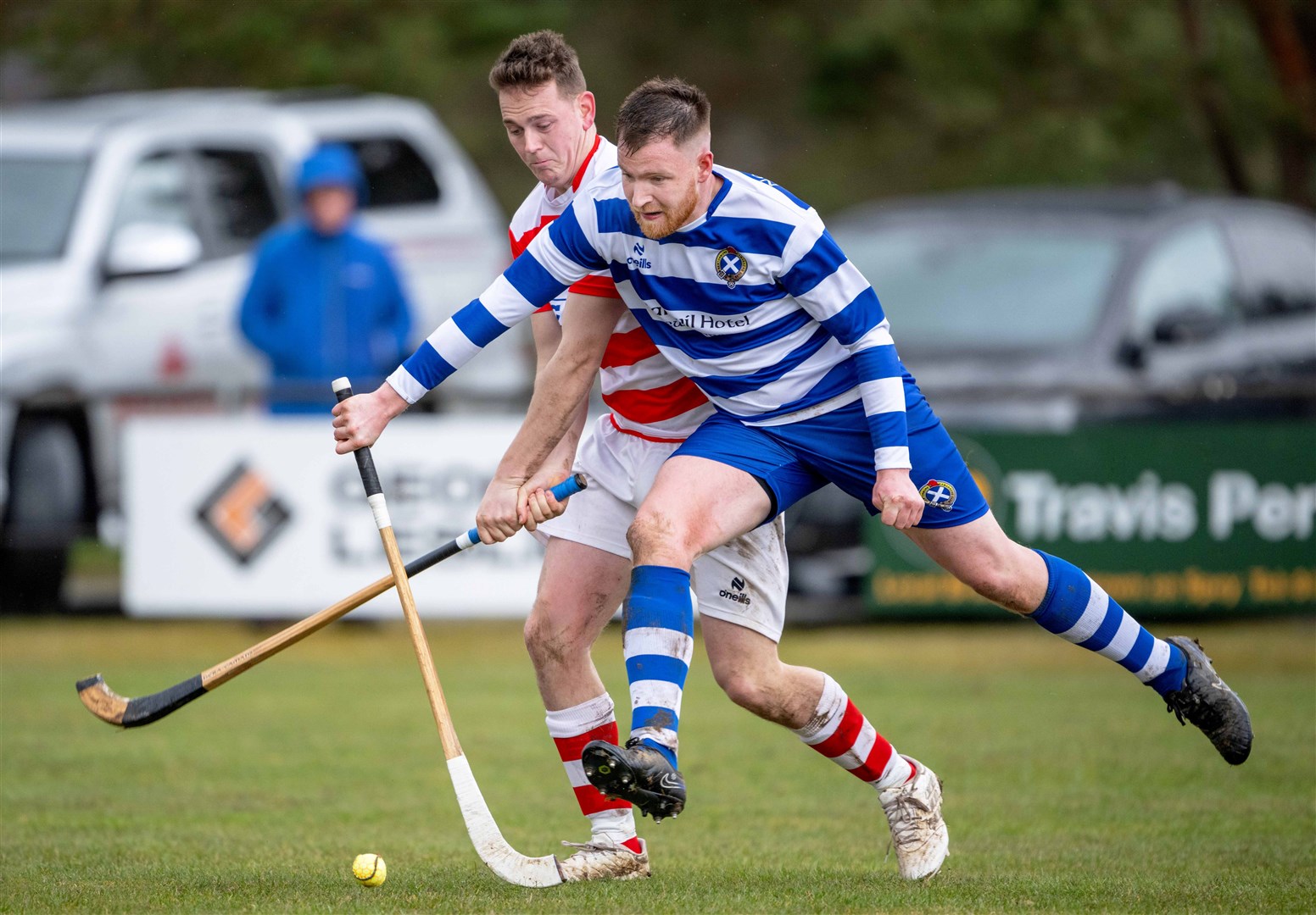Newtonmore's Craig Ritchie with Barry Macdonald (Lochaber). Newtonmore v Lochaber in the Mowi Premiership, played at The Eilan, Newtonmore.