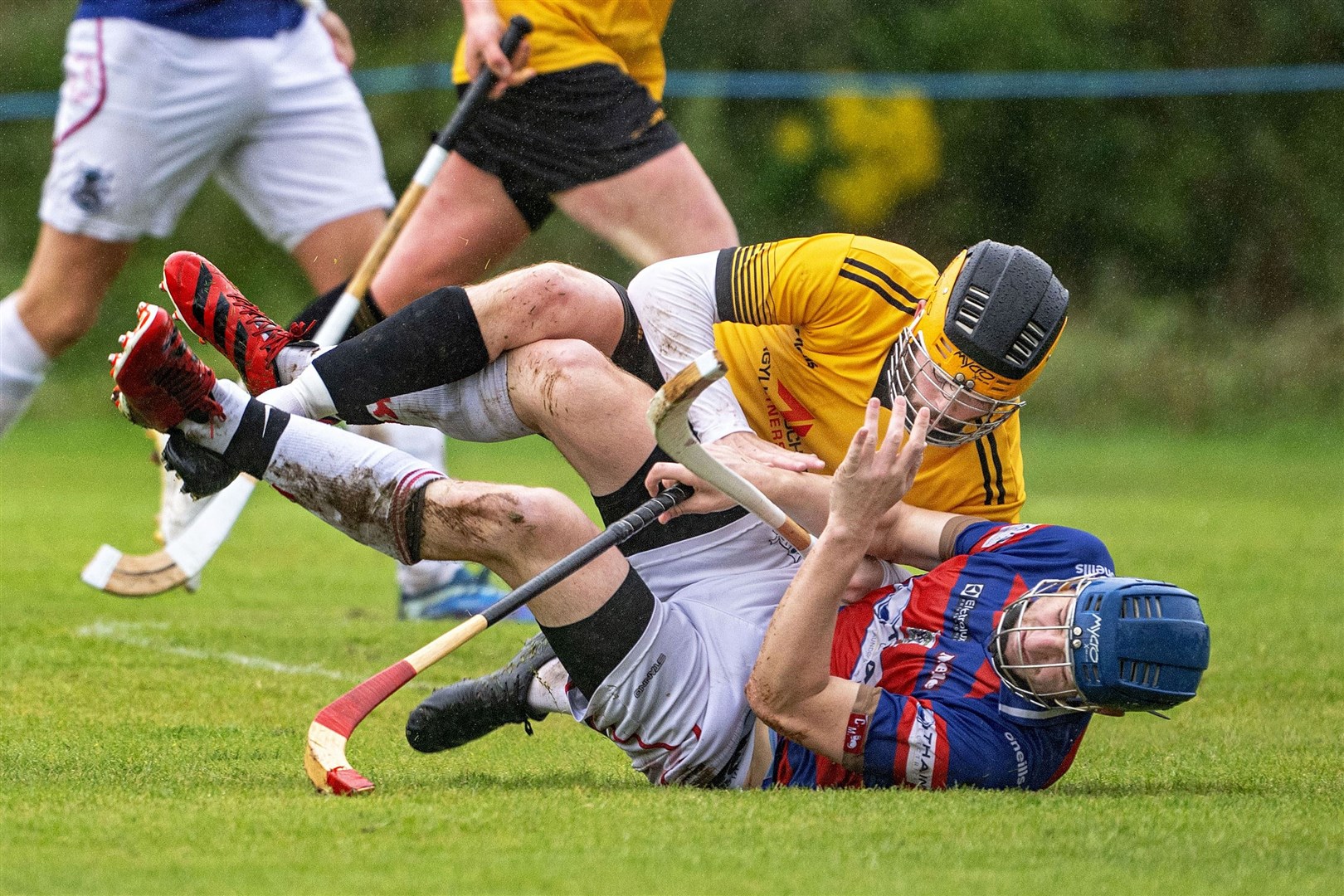 Fort William's Lachie Shaw in a pile up with Robert Mabon (Kingussie) in last Saturday's Camanachd Cup semi-final at Spean Bridge. Picture: Neil Paterson.