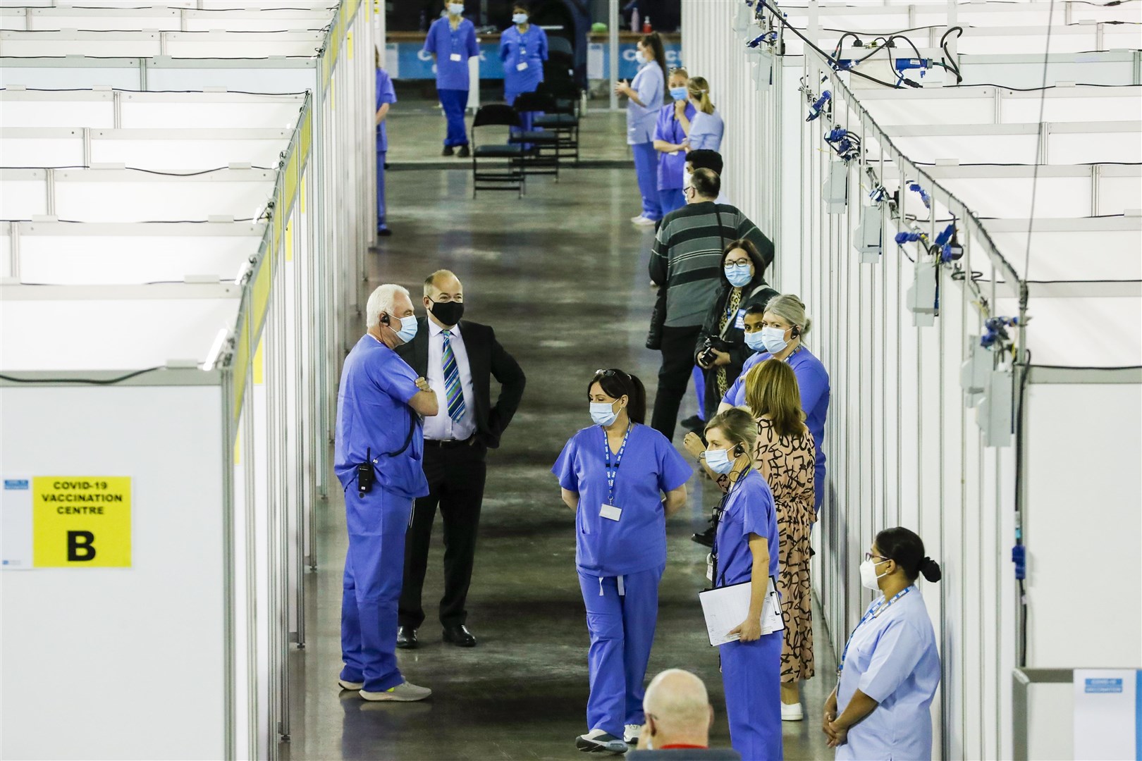 Chief medical officer for Northern Ireland Michael McBride (second from left) speaking with staff at the Covid-19 vaccination centre in the SSE Arena, Belfast (Liam McBurney/PA)