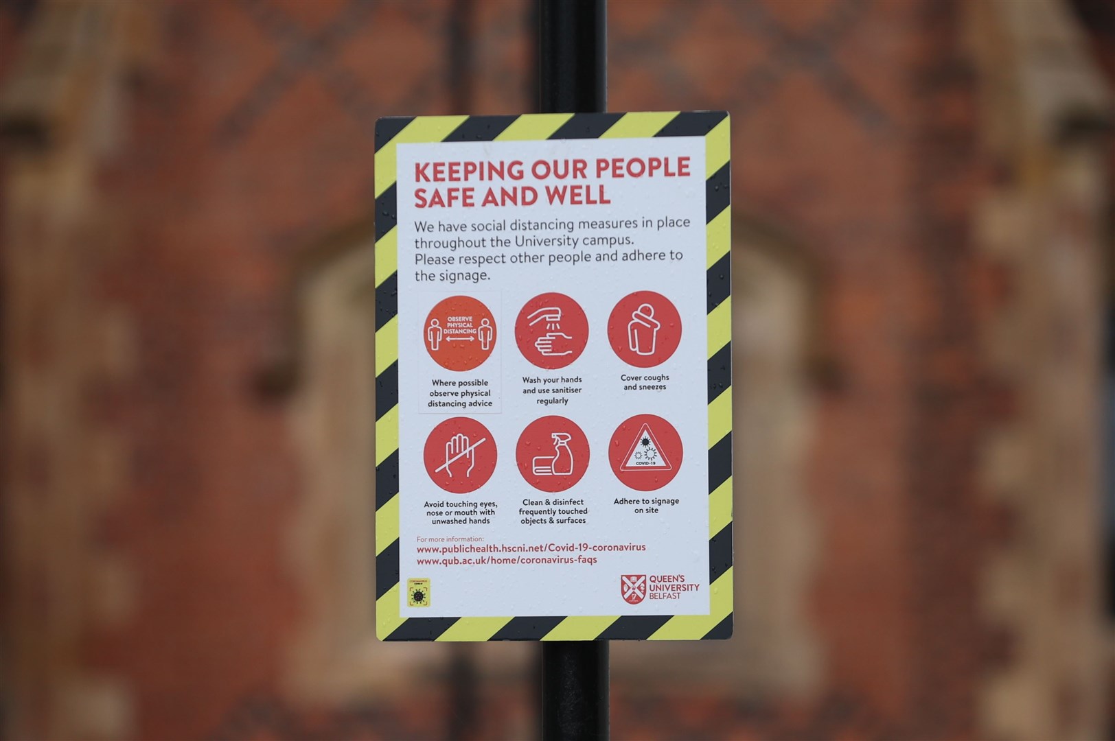 A sign outside Queen’s University in Belfast (Liam McBurney/PA)