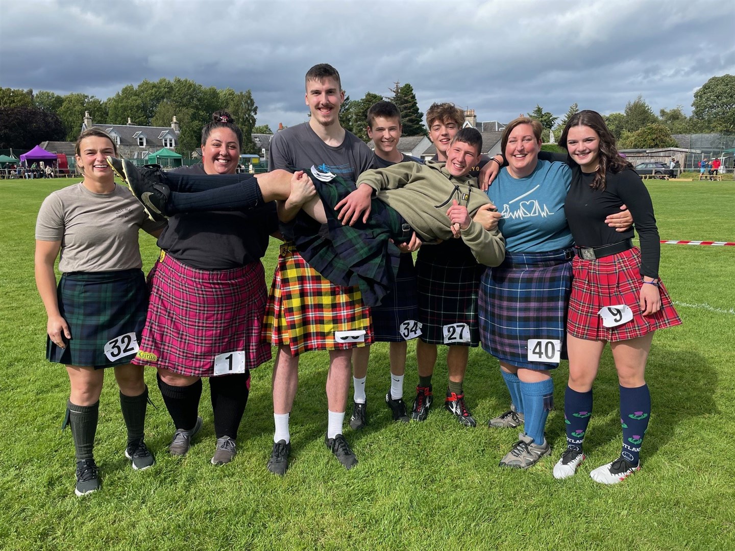 The ladies and junior heavies get together for a photo in the games arena.