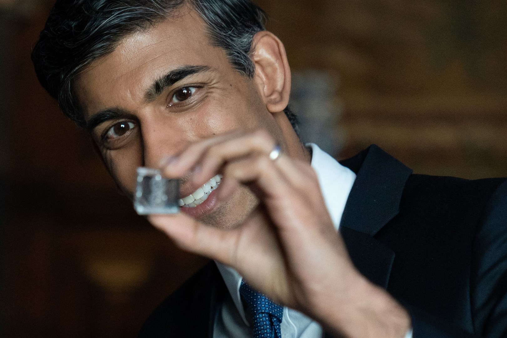 Prime Minister Rishi Sunak examines a fuel capsule produced by nuclear fusion firm First Light at the Hampton Court summit (Stefan Rousseau/PA)