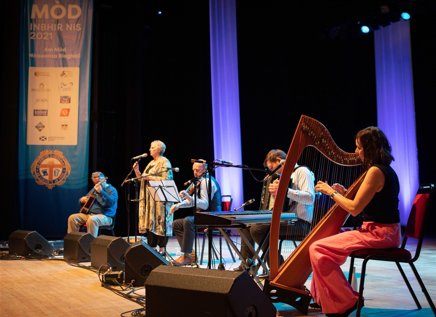 Glenfinnan Ceilidh Band perform on stage awith special guest Gaelic singer, Margaret Stewart Eden Court Theatre on the openng night of live music, The Royal National Mòd 2021