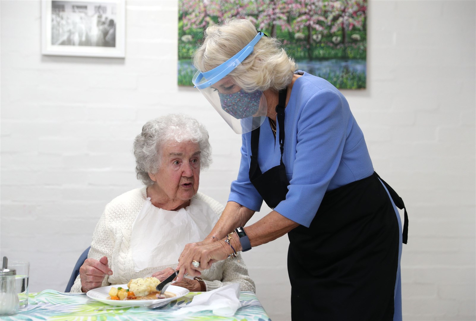 The Duchess of Cornwall wore a face mask and visor as she helped serve lunch (Andrew Matthews/PA)