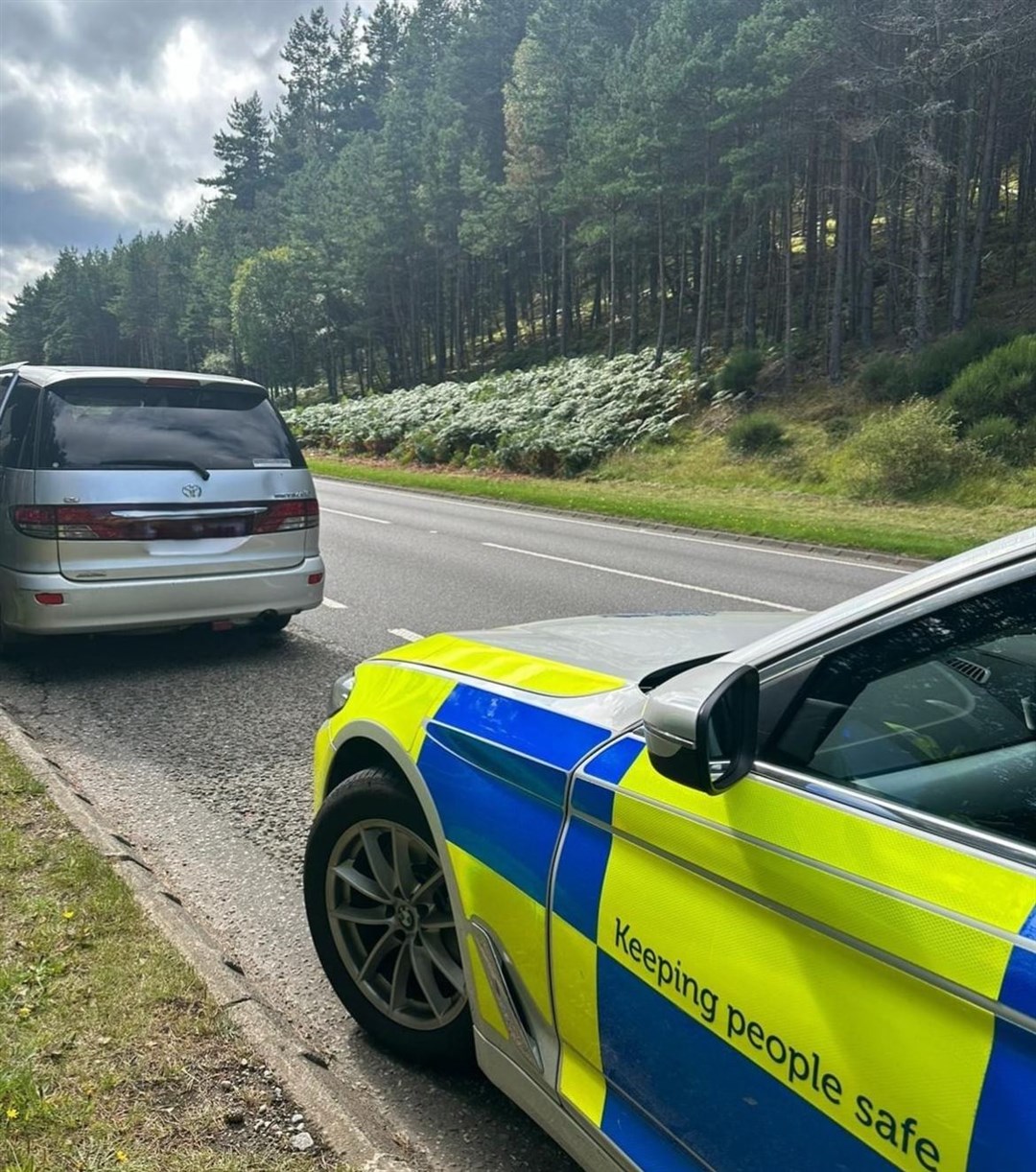 Police with the car which they stopped on the A9 near Aviemore.