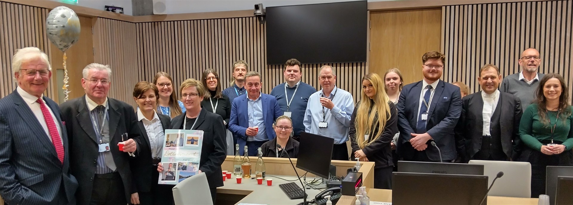 Iain Dunbar (front row, second from left) receives a presentation by senior Sheriff Eilidh Macdonald (front row, third from left).