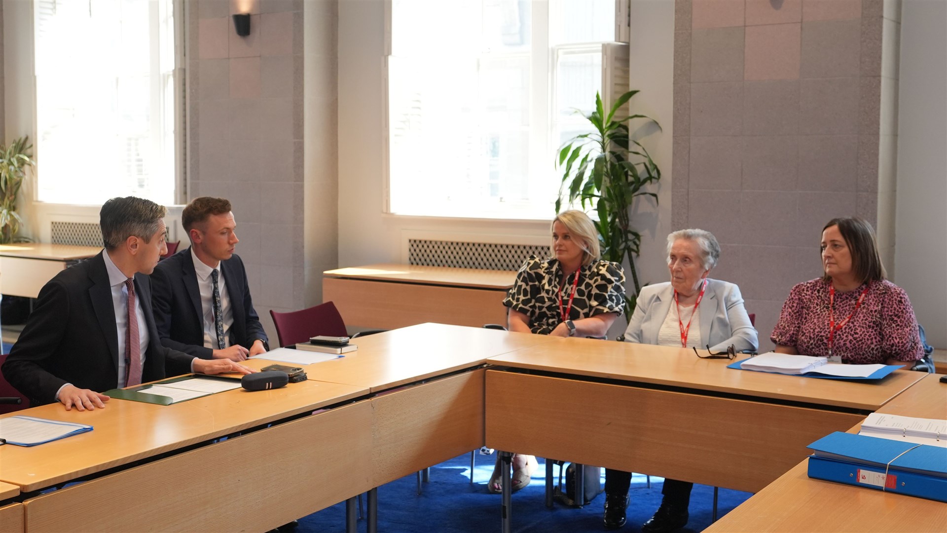Tanaiste Simon Harris (left) speaking to Sean Brown’s widow Bridie Brown (second right) and daughters Clare Loughlan (centre) and Siobhan Brown (right) (Niall Carson/PA)