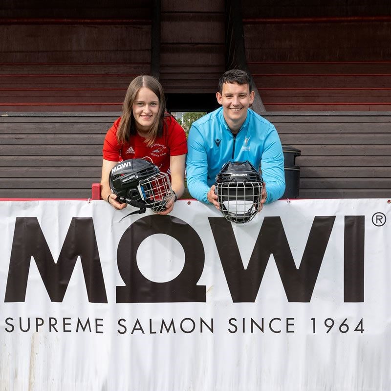 Two young shinty players with the new helmets