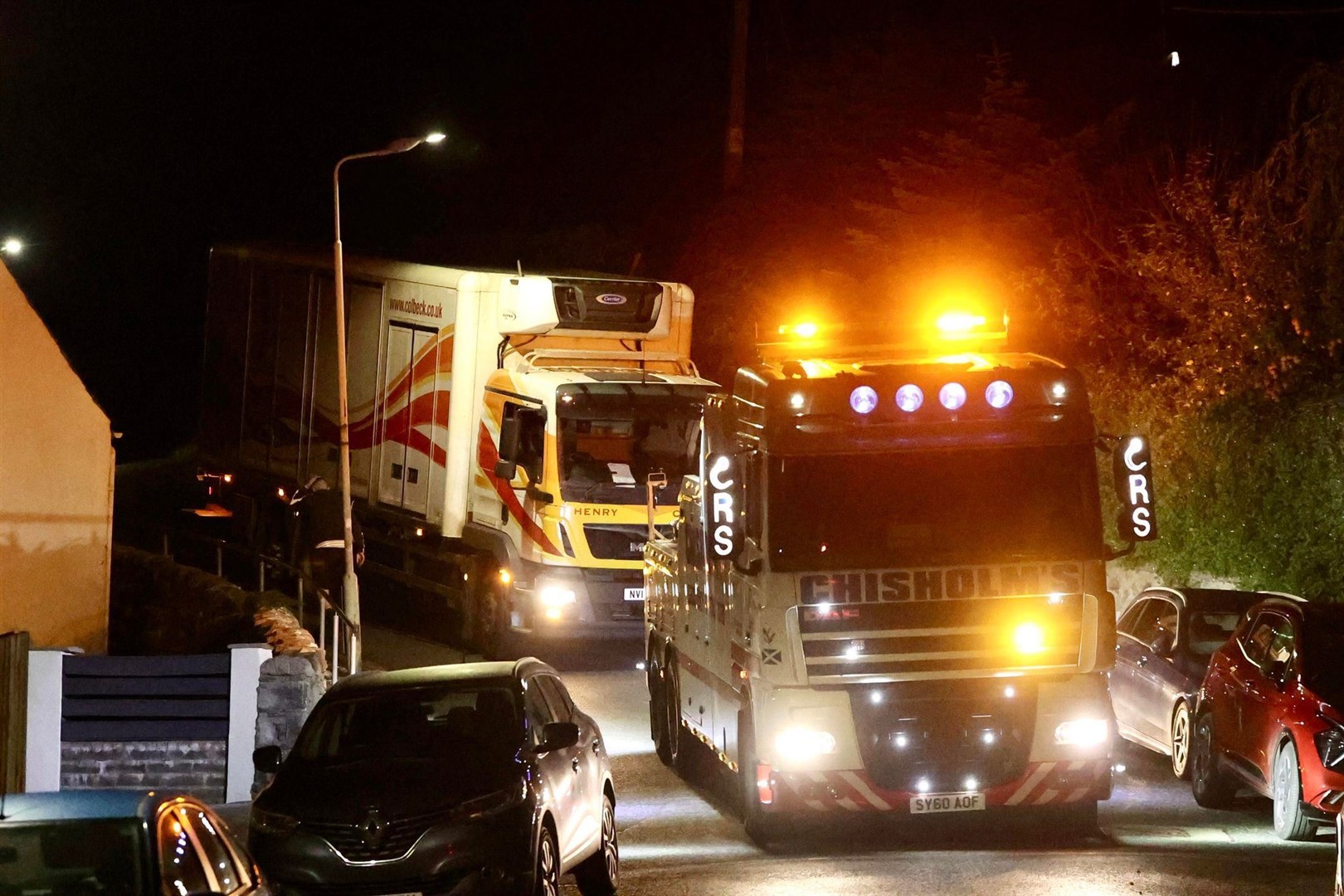 Safely released: the frozen foods lorry is hauled off the corner of the junction.