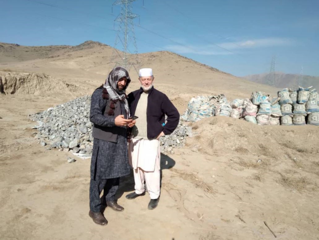 Peter Jouvenal, right, with a mining consultant, collecting potential rock samples in Afghanistan before his arrest (Peter Jouvenal/PA)