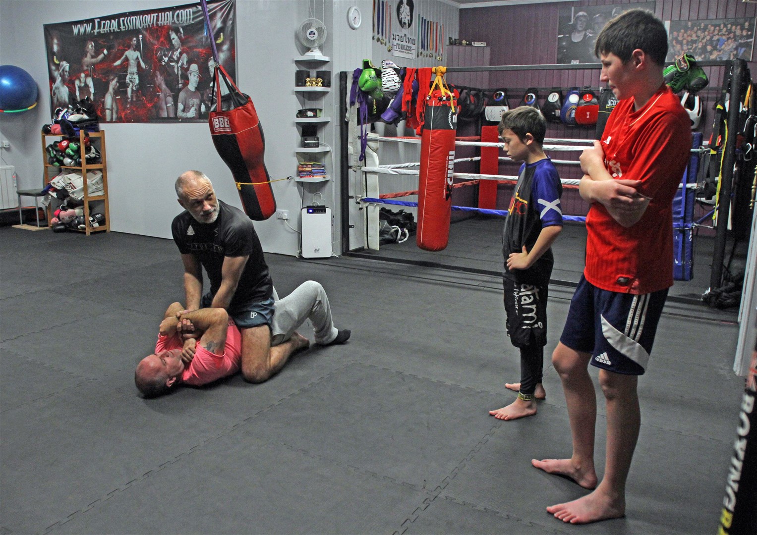 Hayden and Torran Haworth watch dad Phil demonstrate a technique on fellow club organiser Robbie Macpherson.