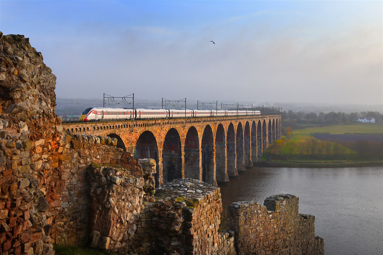 An LNER Azuma train crossing the Royal Border Bridge on the outskirts of Berwick.