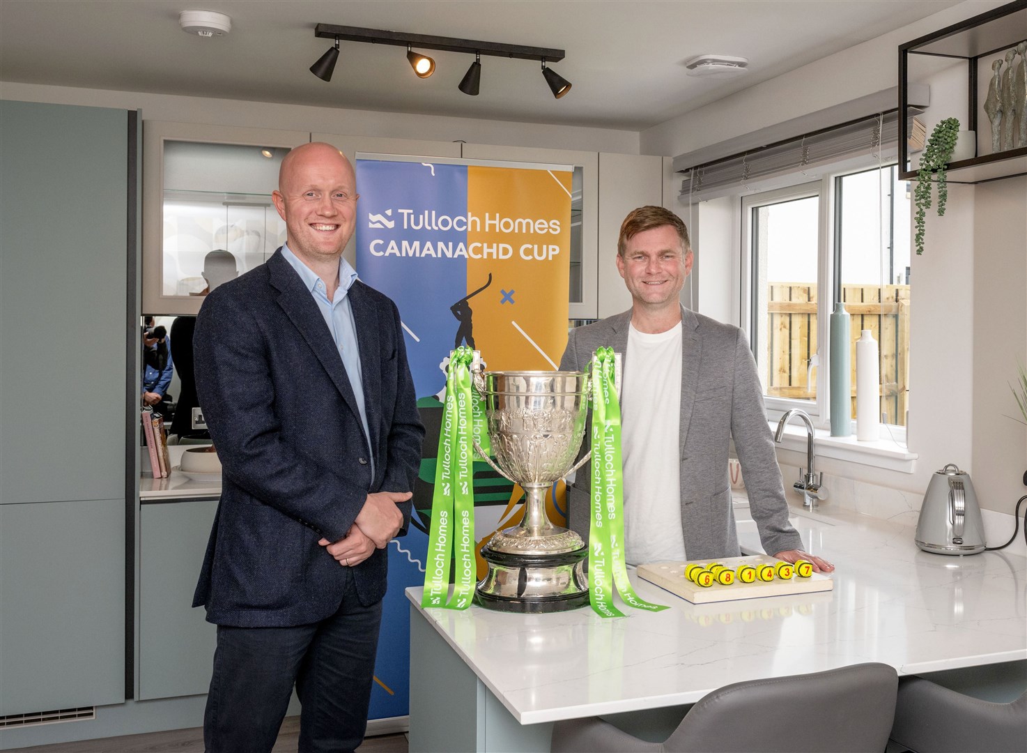 Tulloch Homes managing director Kieran Graham and Camanachd Association CEO Ruari Davidson alongside the Tulloch Homes Camanachd Cup following the quarter-final draw. Picture: Neil Paterson.