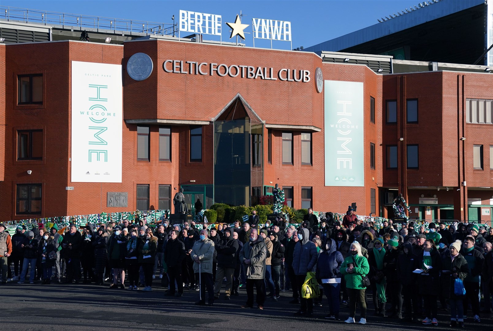 Mourners outside Celtic Park during the funeral procession for former Celtic player Bertie Auld (Andrew Milligan/PA)