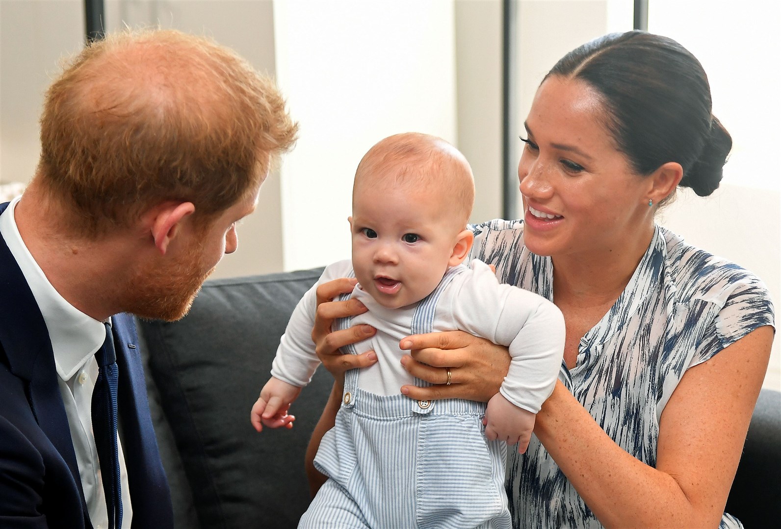 Harry and his wife Meghan holding their son Archie (Toby Melville/PA Images)