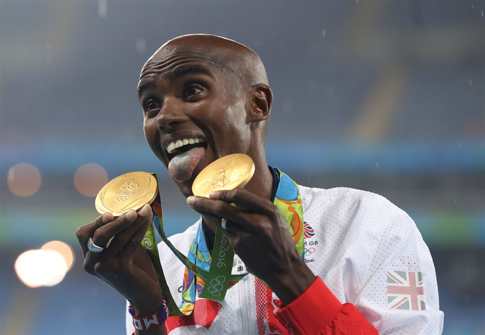 Great Britain’s Mo Farah celebrates with his gold medals after winning the men’s 5000m and 10,000m at the Rio Olympic Games (Martin Rickett/PA)