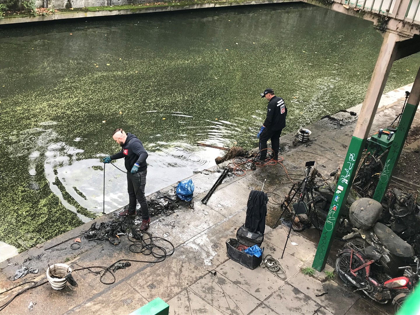 Magnet fishers Nigel Lamford and Jim Norton trawl Regent’s Canal for metal objects (Laura Parnaby/PA)