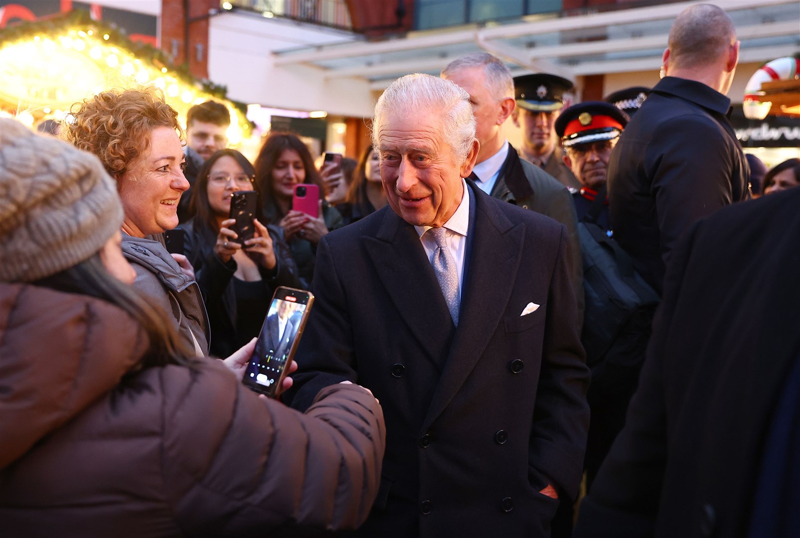 The King was mobbed by scores of shoppers who took photos of him on their smartphones (Peter Nicholls/PA)