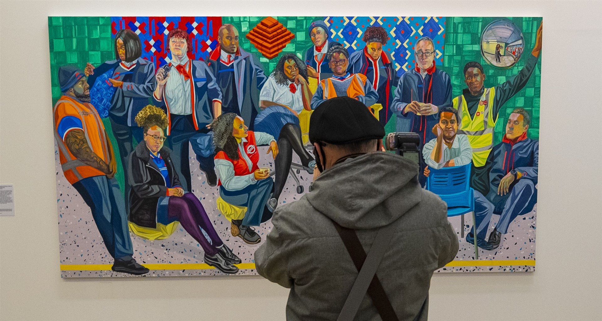 A man looks at a painting in Tate Liverpool’s exhibition of NHS worker portraits (Peter Byrne/PA)