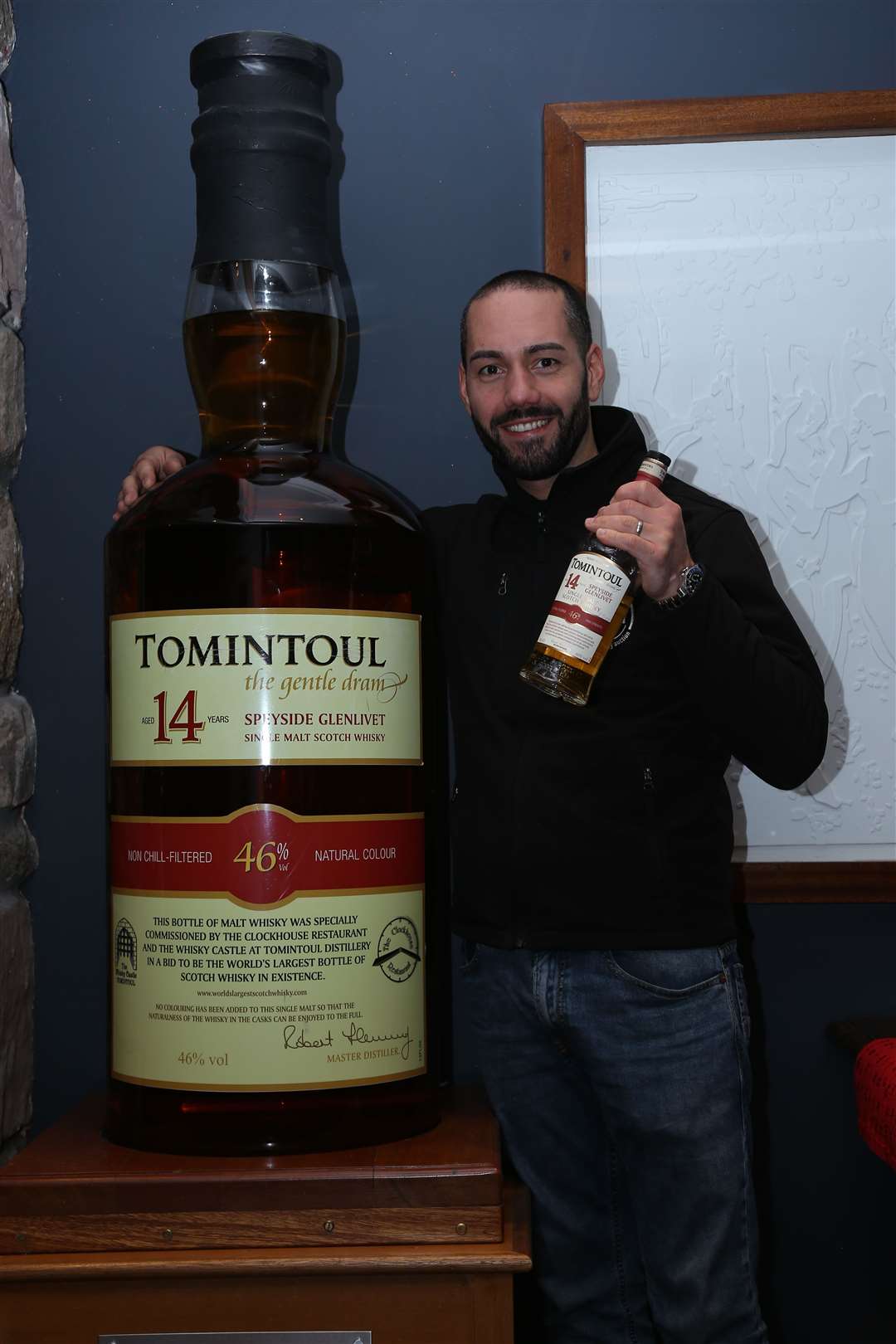 Yuri Bronzina, of Just Whisky, with the bottle of Tomintoul 14-year-old single malt.