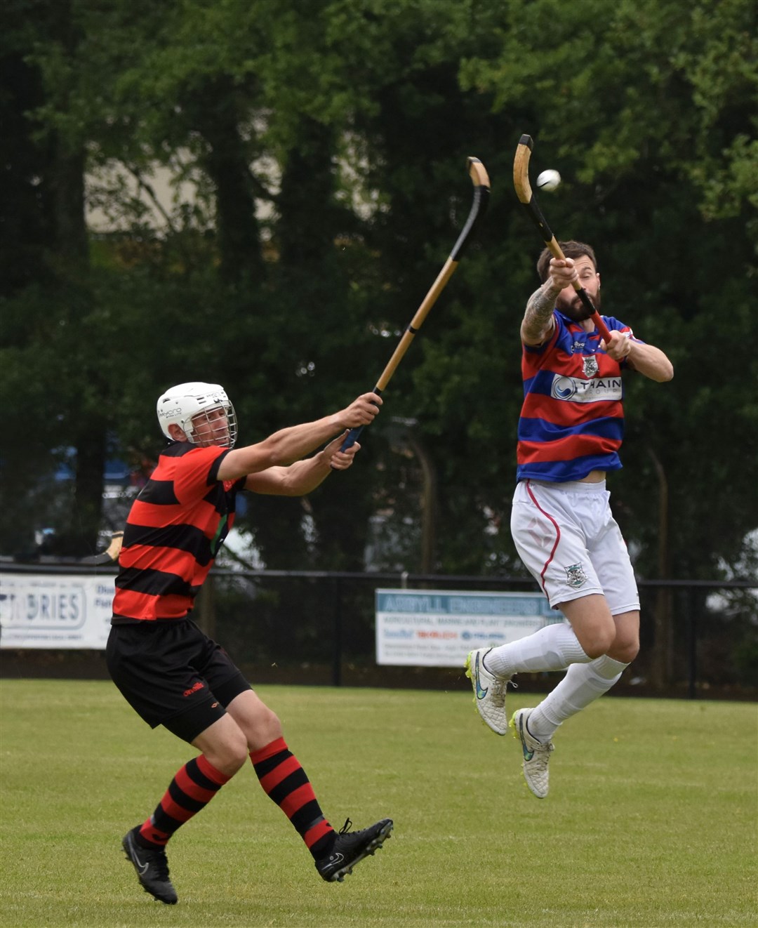 Thomas Borthwick gets to the ball first in Saturday's 1-1 draw with Oban Camanachd. Picture: Fiona Young.