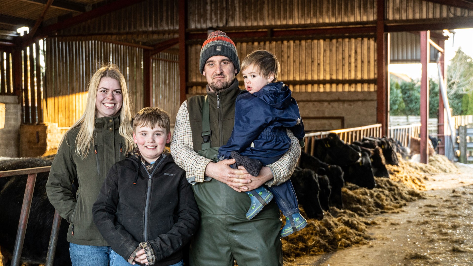 Our Farming Life... Jenni and Robert in the byre with sons Marcus and Donnie and some of their cattle.