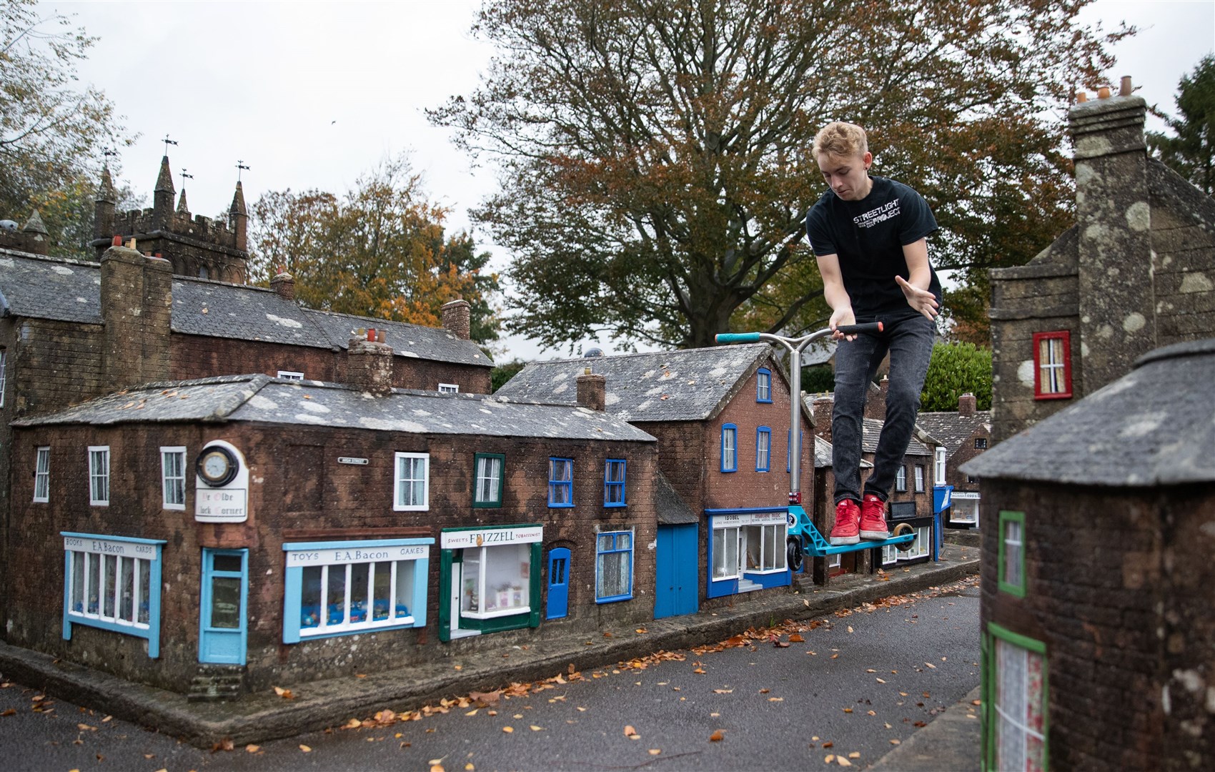 Charlie Sibley, from the StreetLight Project, scooters through the streets of Wimborne Model Town and Gardens in Dorset (Andrew Matthews/PA)