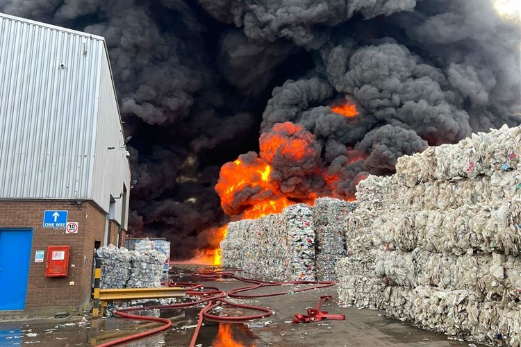 Black smoke seen as firefighters tackle large fire at recycling warehouse