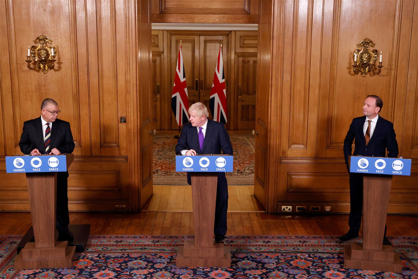 Professor Jonathan Van-Tam, Prime Minister Boris Johnson and Sir Simon Stevens during a media briefing in Downing Street (John Sibley/PA)