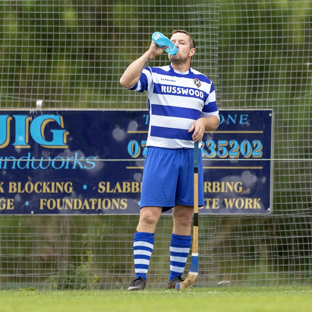 Thirsty work: 4 goal hero Glen Mackintosh (Newtonmore) takes on water during the game.