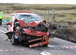 The mangled remains of the car and the motorbike to its right after the crash.