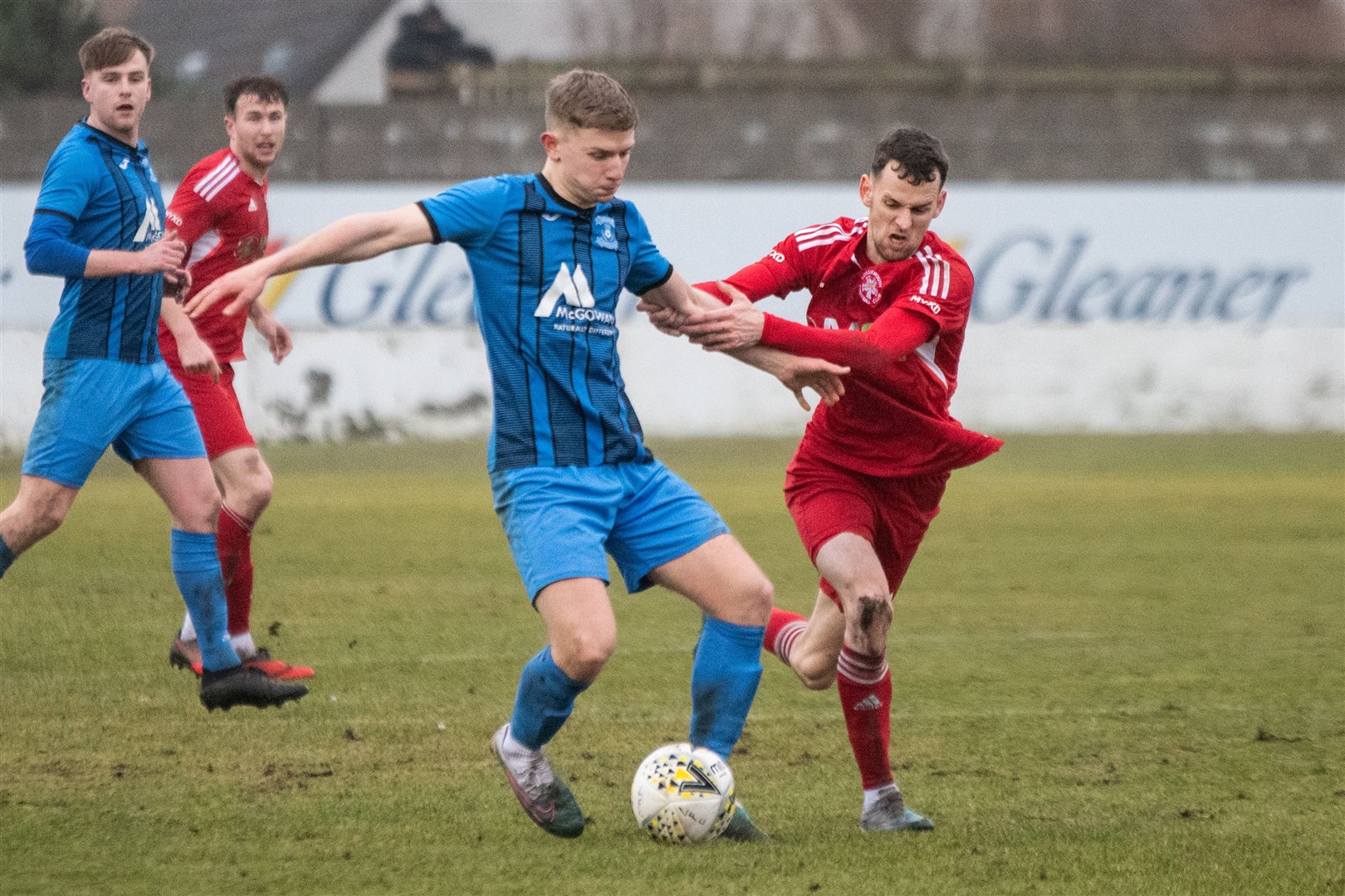 Lossie's Ryan Farquhar gets a grip on Strathspey's Jack Davison...Lossiemouth FC (2) vs Strathspey Thistle (1) - Highland Football League 23/24 - Grant Park, Lossie 10/02/2024...Picture: Daniel Forsyth..