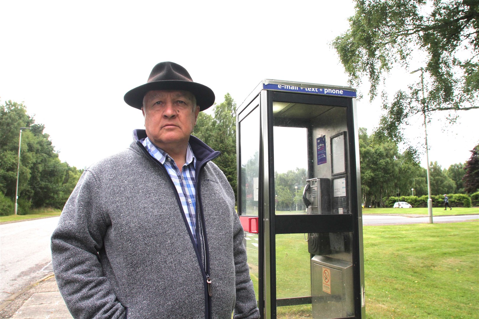 Councillor Bill Lobban at the public payphone on Dalfaber Drive in Aviemore.