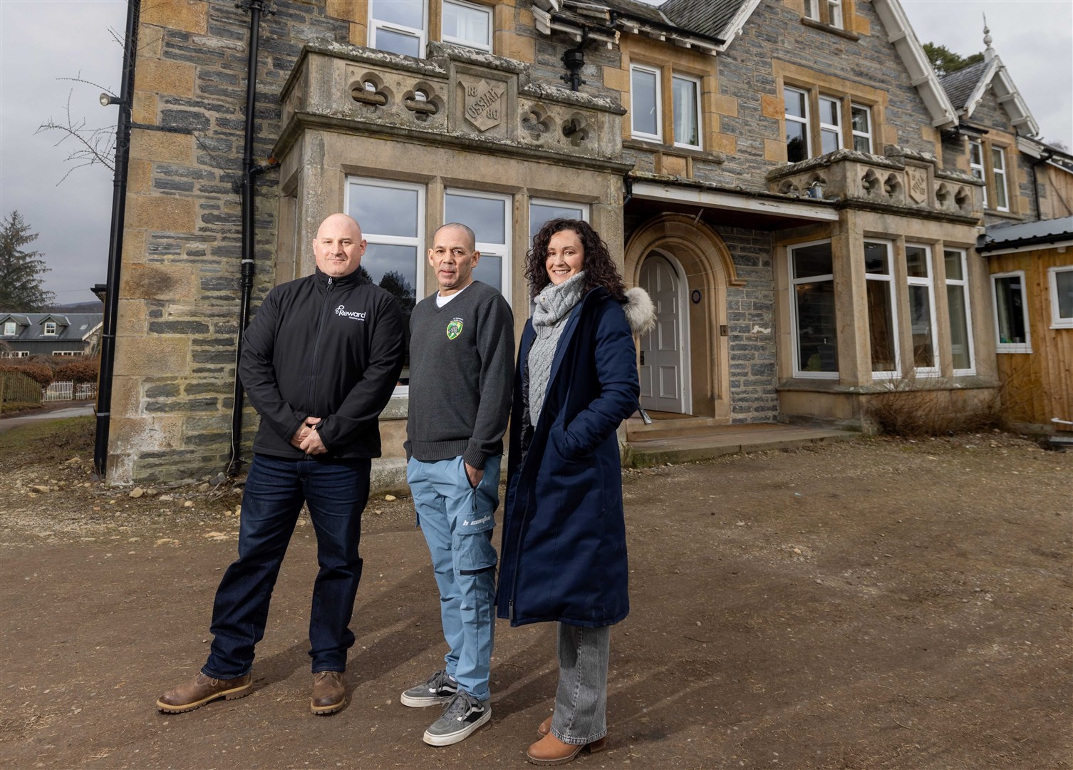 Brian Machray (Reward Finance Group), Tony Brown (Forces Manor) and Lucie Martin (Reward Finance Group) in front of Forces Manor in Kincraig.