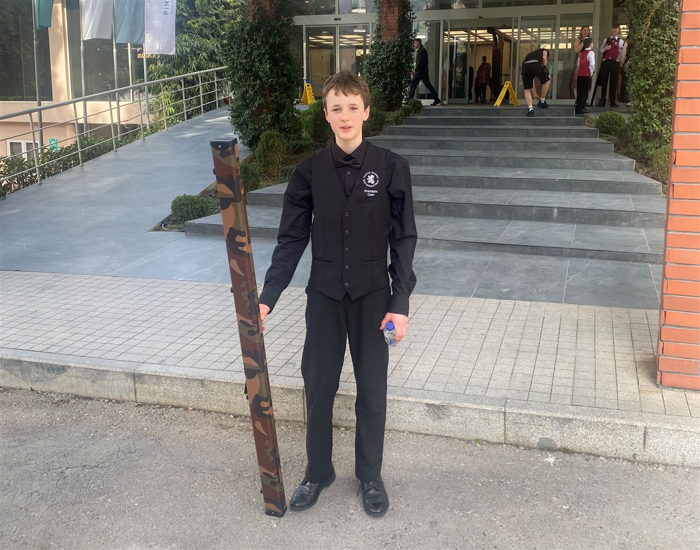 Elijah Versteeg armed with his cue outside of the competition venue.