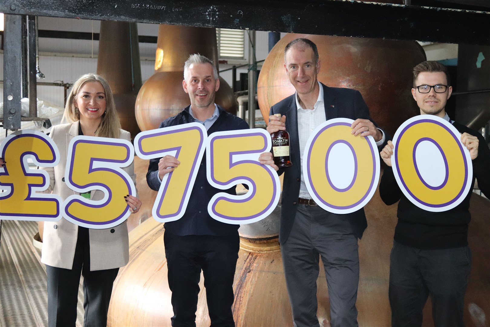 Emma Nicol, community and events fundraiser with Highland Hospice; Stephen Bremner, managing director of Tomatin Distillery; Kenny Steele, chief executive of Highland Hospice and Niall Ross, communications officer with Highland Hospice.