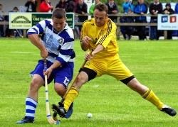 Inveraray’s Andrew McMurdo lunges in to try and block Newtonmore’s Glen Mackintosh’s attempt to play the ball during their Camanachd Cup semi-final on Saturday. Both semi-finals were played at Spean Bridge.