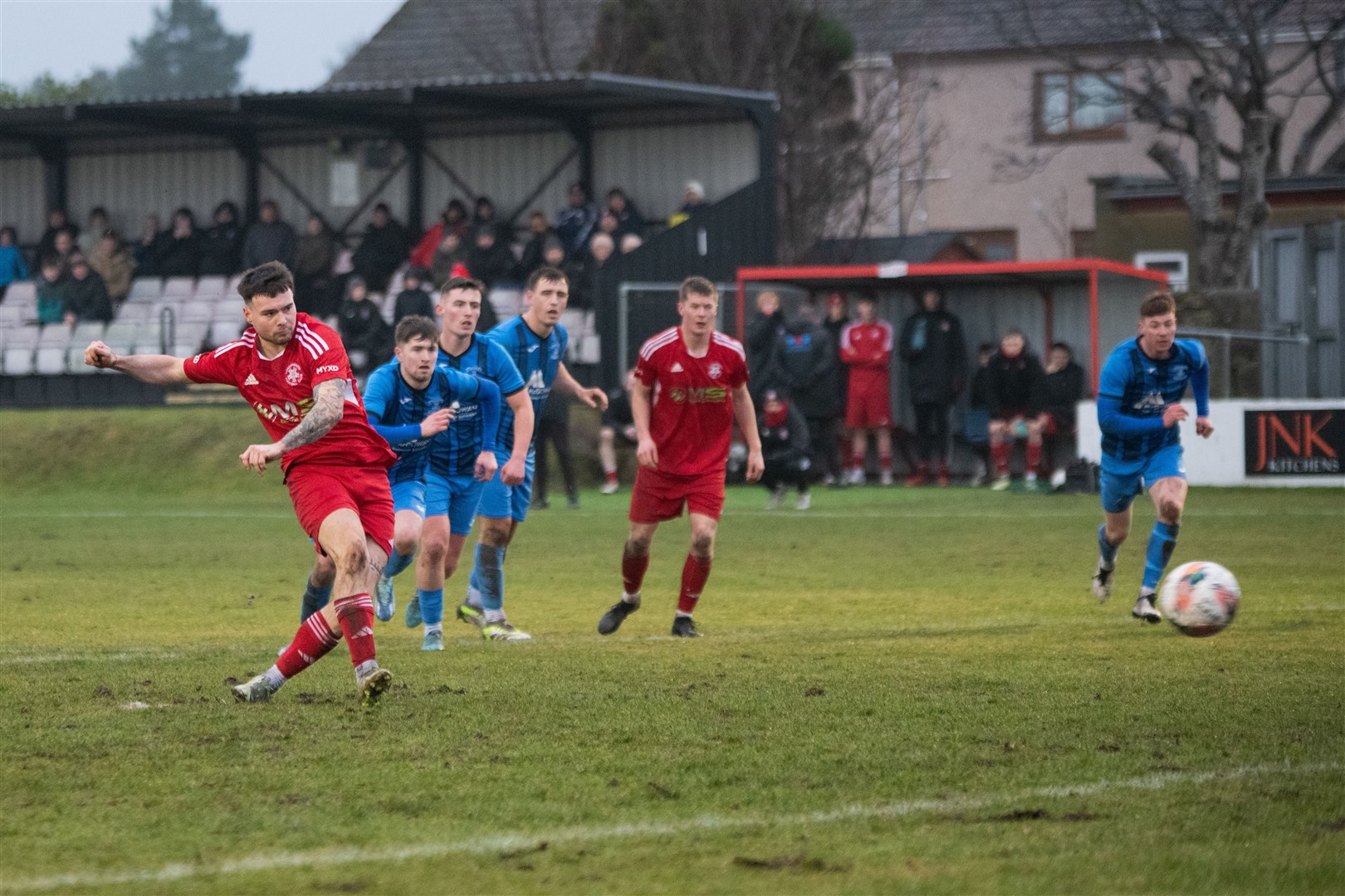 Lossiemouth's Niall Kennedy sweeps home a penalty for the Coasters. ..Lossiemouth FC (2) vs Strathspey Thistle (1) - Highland Football League 23/24 - Grant Park, Lossie 10/02/2024...Picture: Daniel Forsyth..