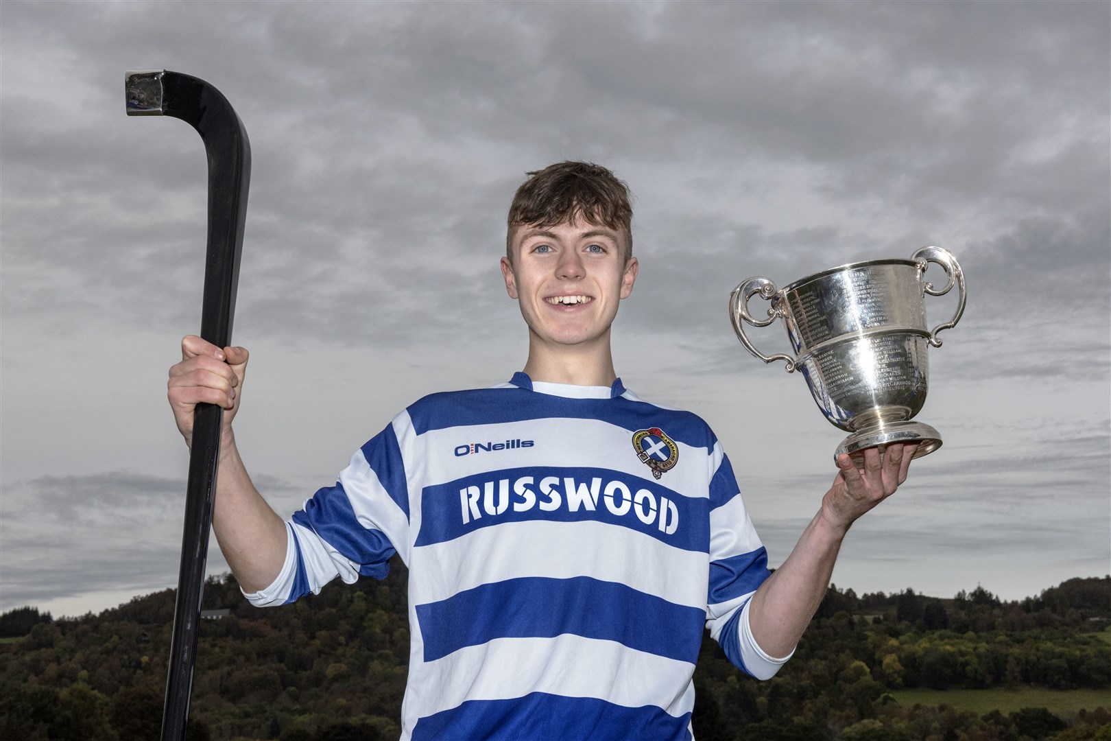 Newtonmore captain Sorley Thomson with the Sutherland Cup.