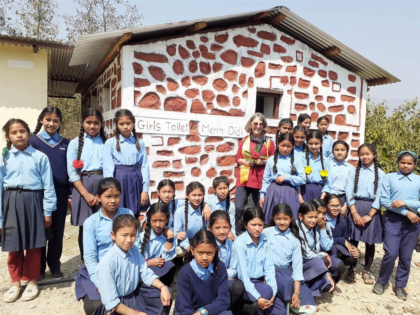 THE CAUSE: Marian Burrows-Smith is pictured in Nepal with one of the toilet blocks which are ensuring that young girls will have the confidence to attend their rural schools