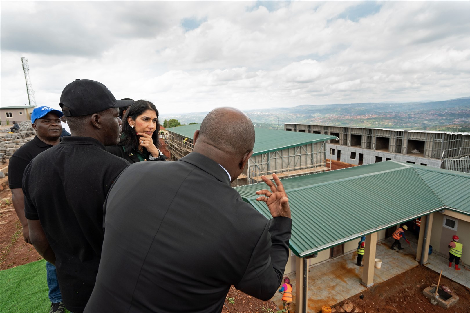 Home Secretary Suella Braverman tours a building site on the outskirts of Kigali during her visit to Rwanda, to see houses being constructed that could eventually house deported migrants (Stefan Rousseau/PA)