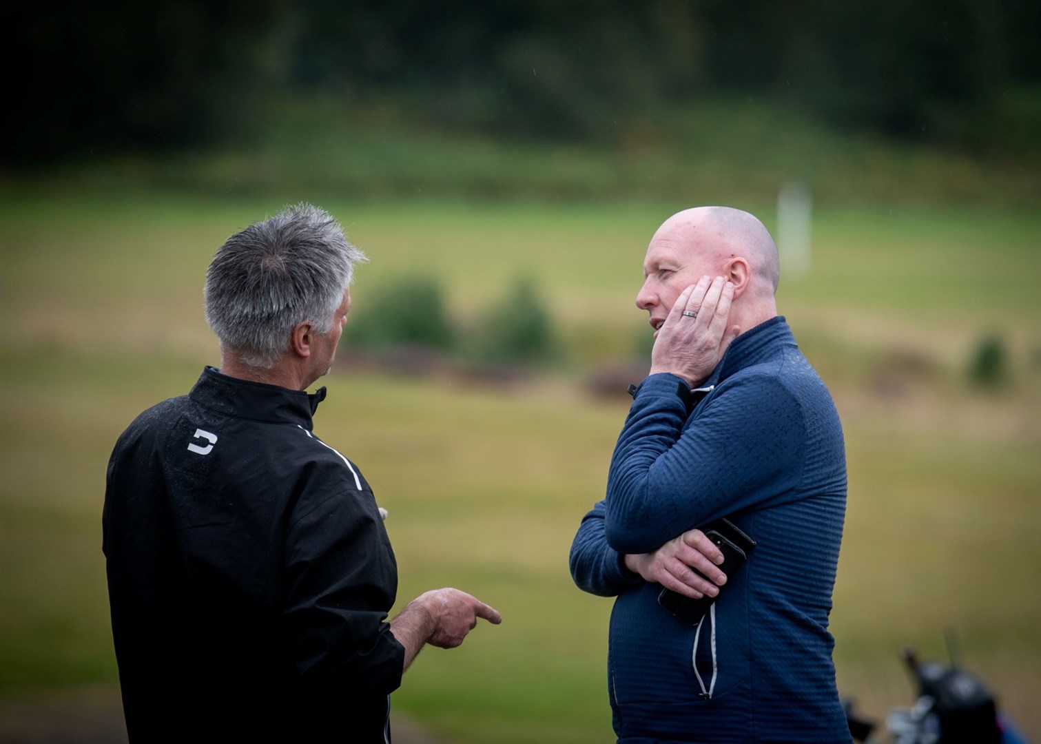 Deep in conversation at the pro-am.