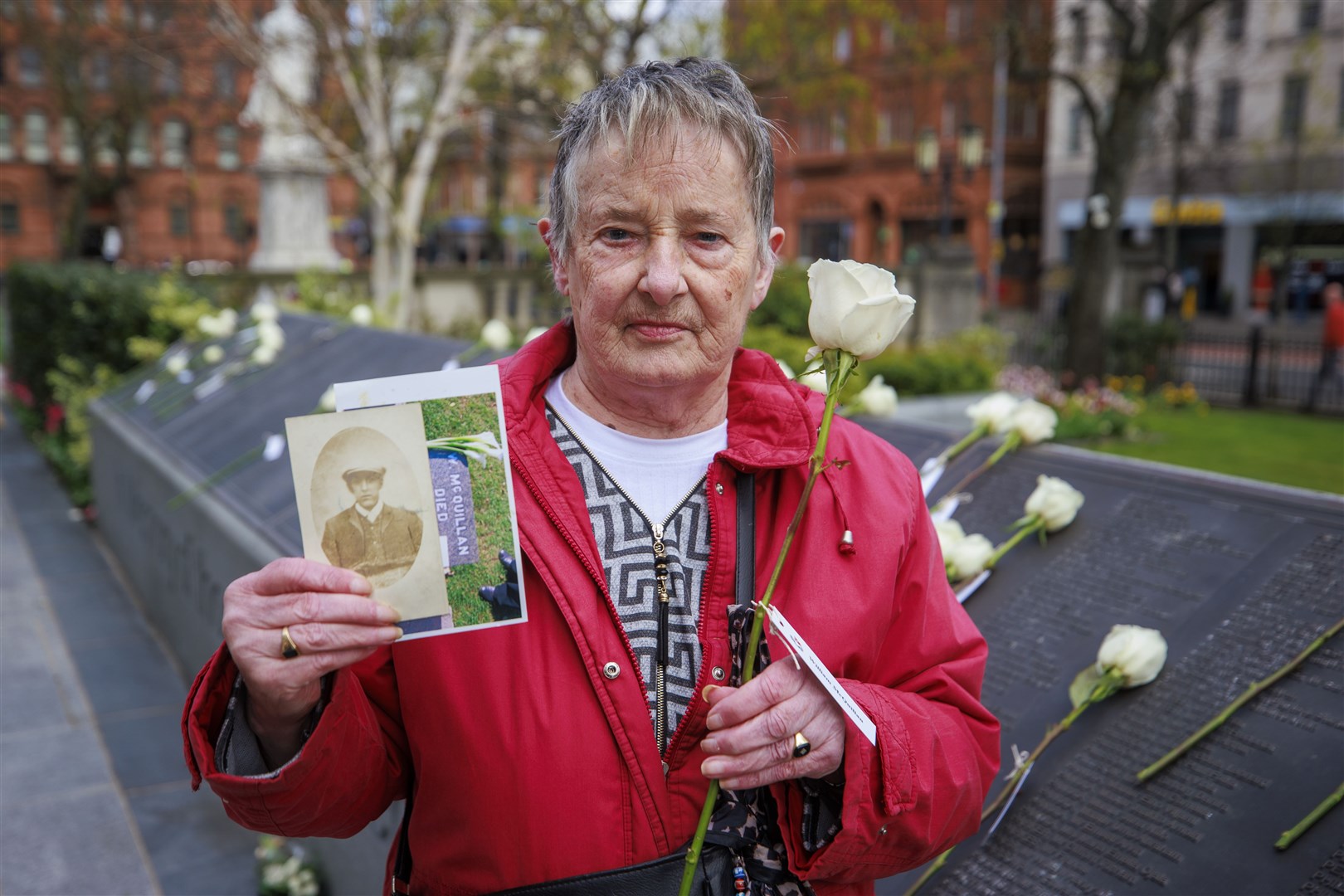 Marjorie Wilson holds an image of her grandfather William McQuillan (Liam McBurney/PA)