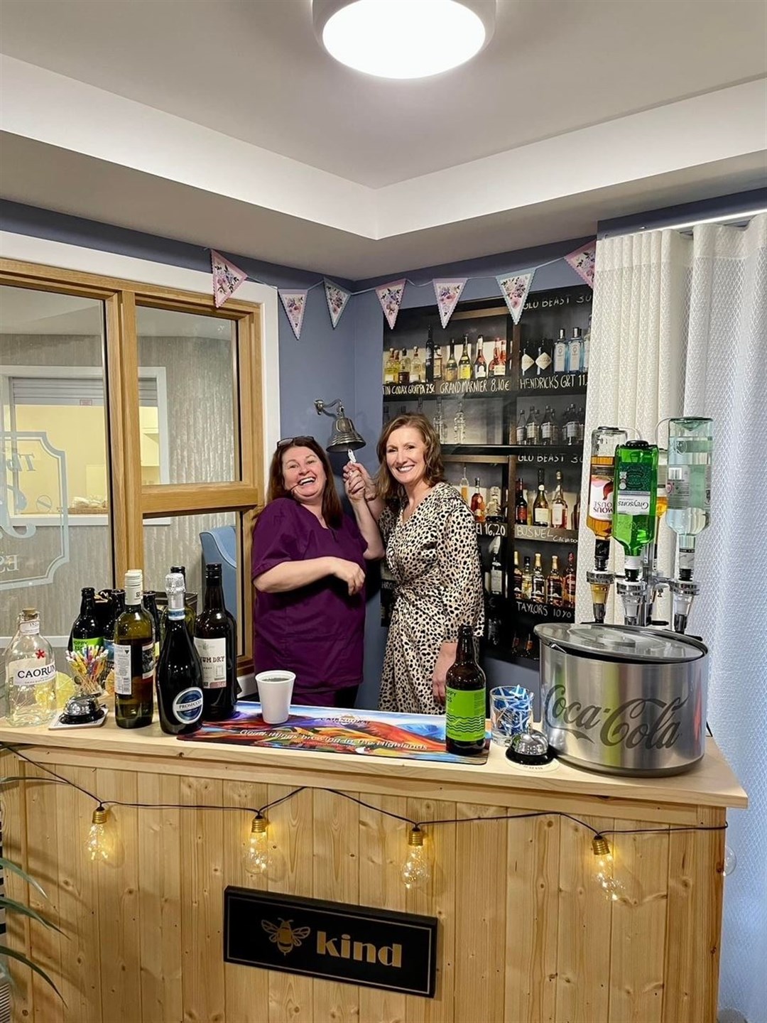 Manager Shona Conlin and Parklands Operations Director Elaine Taylor ring the bell at the bar which was officially opened on St Andrews Day.