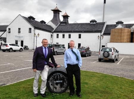 Mr Hendry (left) is welcomed by Mr Mackenzie with the iconic distillery in the background