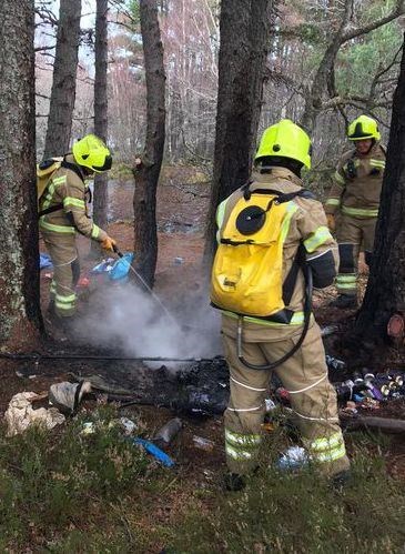 Firefighters from Kingussie tackle a camp fire left burning in woods by Loch Morlich last year.