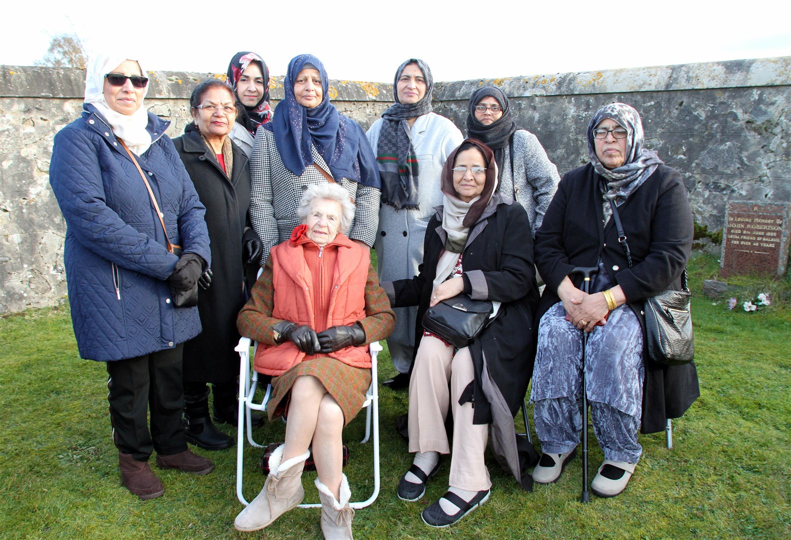 Isobel Harling with family of the Indian soldiers laid to rest in the graveyard on the outskirts of Kingussie.