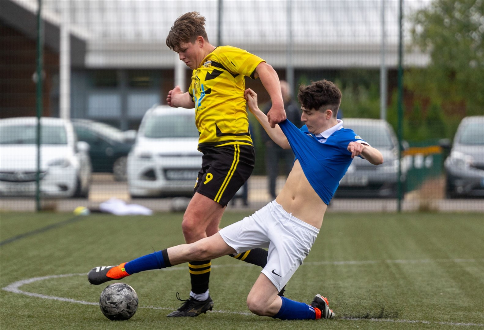 Badenoch United's Svend Pedersen keeps Rover's Ryan Stewart at arm's length.