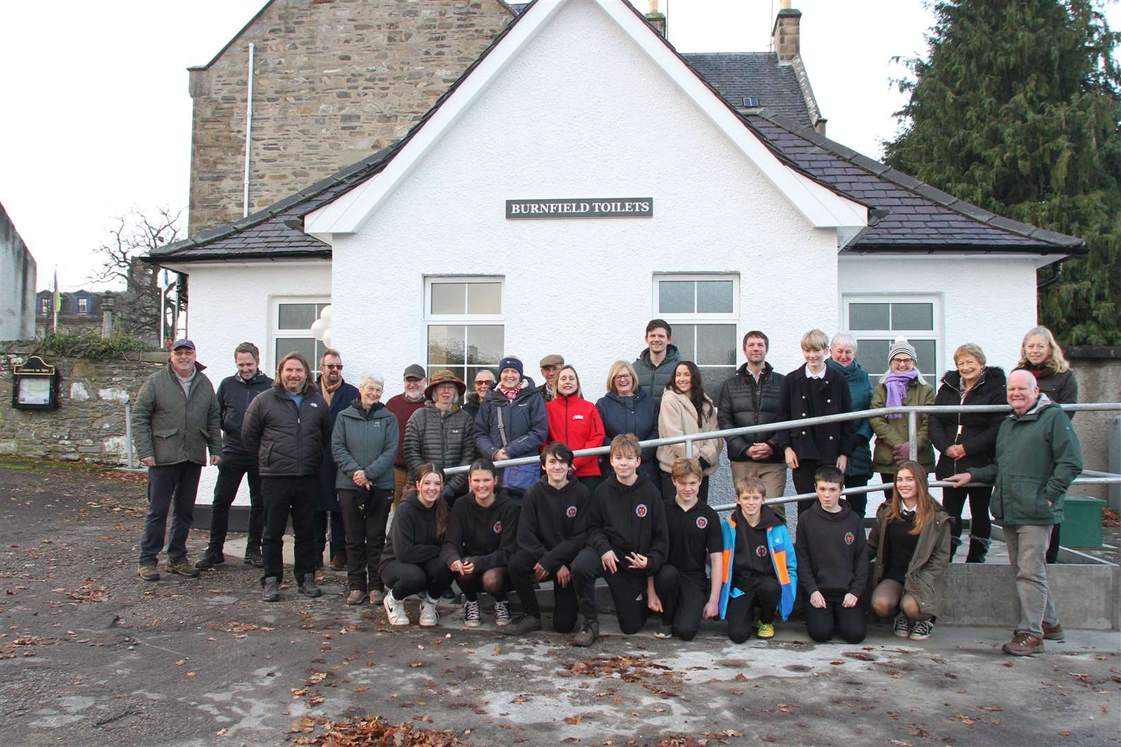 Project supporters gather for the reopening of the improved public conveniences.
