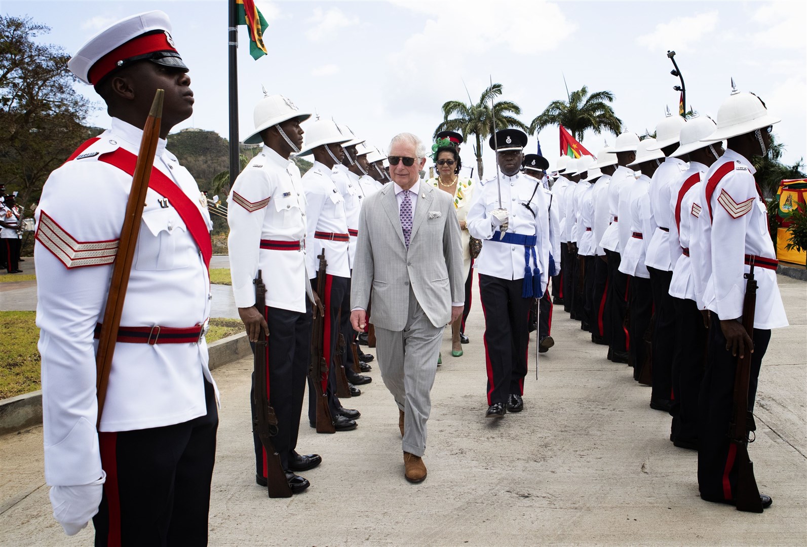 The then Prince of Wales inspects the troops during a welcome ceremony and reception at the Grenada Houses of Parliament building during a visit to the Caribbean island in 2019 (Jane Barlow/PA)